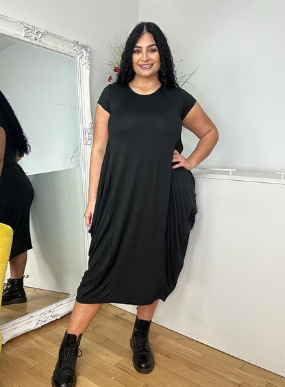 woman with long black hair wearing a black short sleeve dress