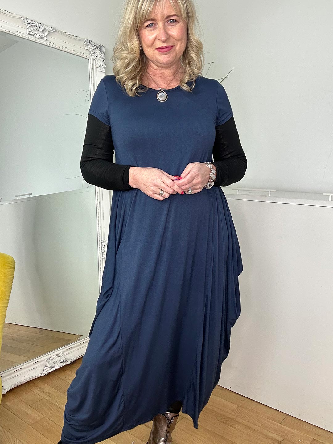 woman with long blonde hair wearing a blue short sleeve dress