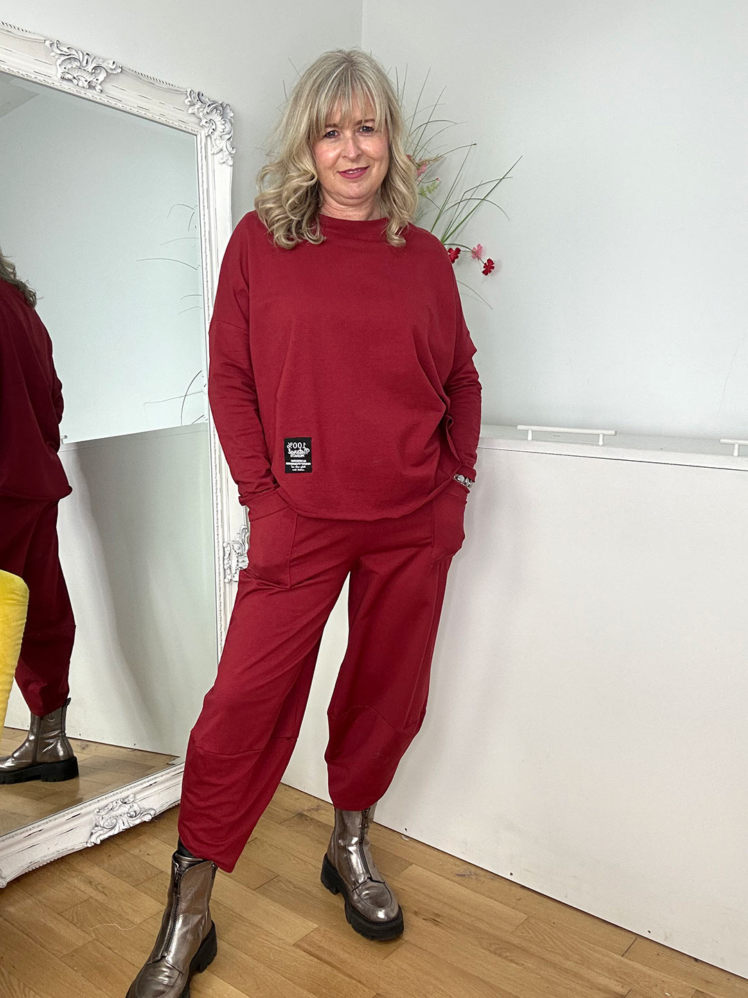 blonde woman wearing red two piece outfit with long sleeves